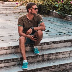 Full length of young man sitting on staircase