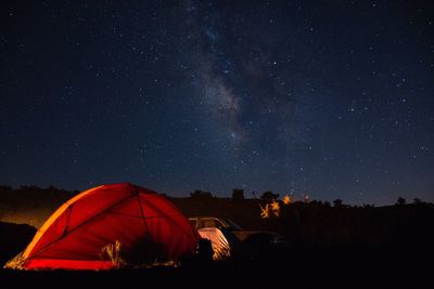 Tent on mountain against sky at night