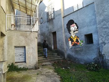 Man walking in front of building