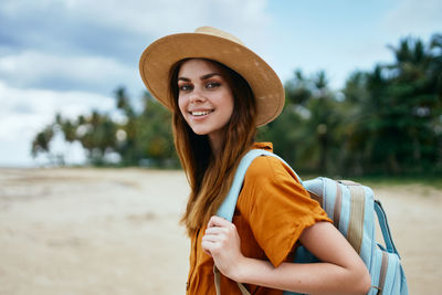 Portrait of smiling young woman wearing hat