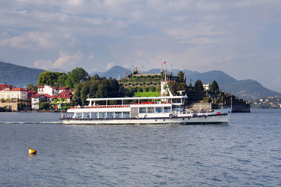 Boat in river by building against sky