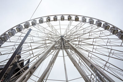 Low angle view of ferris wheel against sky