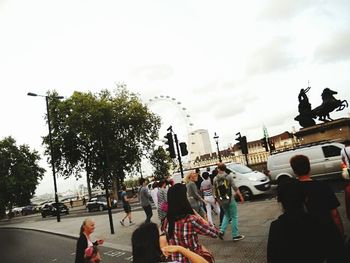 People in town square against sky