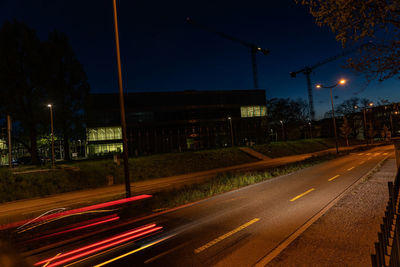 Light trails on road in city at night