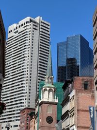 Low angle view of buildings against clear blue sky