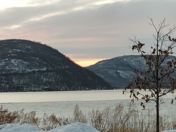 Scenic view of snowcapped mountains against sky during sunset