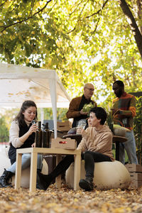 Friends using laptop at park