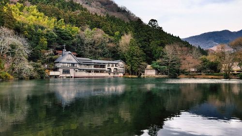 Houses by kinrinko lake against sky