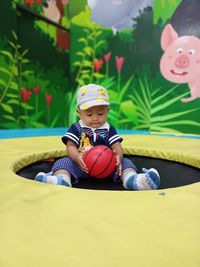 Portrait of boy playing with teddy bear