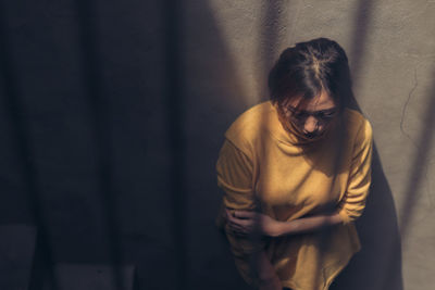 Man standing against wall