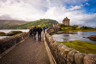 Group of people walking on bridge