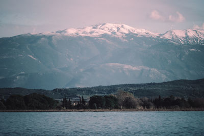 Scenic view of lake and snowcapped mountains against sky