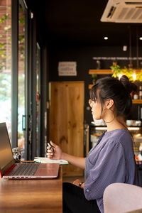 Girl having coffee while working in a cozy environment