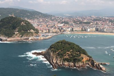 High angle view of townscape by sea against sky