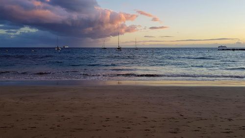 Scenic view of beach against sky during sunset