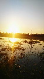 Scenic view of lake against sky during sunset