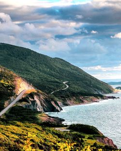 Scenic view of sea and mountains against sky