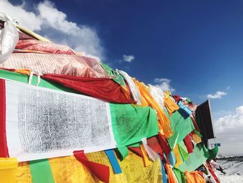 Low angle view of clothes drying on beach against sky