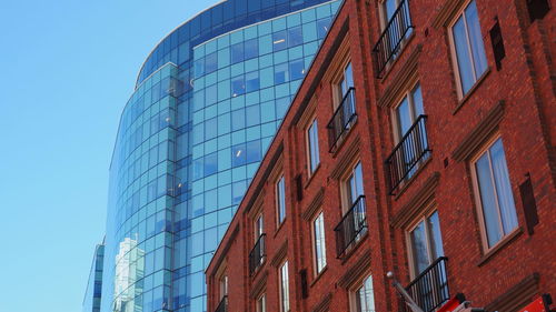 Low angle view of modern buildings against sky