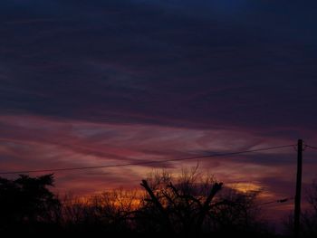 Low angle view of silhouette trees against sky at sunset