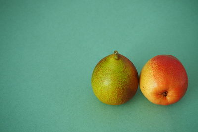 Close-up of apple on table against green background