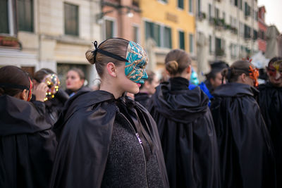 Women wearing mask against buildings8