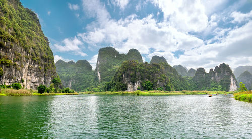Panoramic view of river and mountains against sky