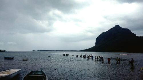 People on beach against sky