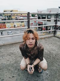Portrait of woman sitting outdoors