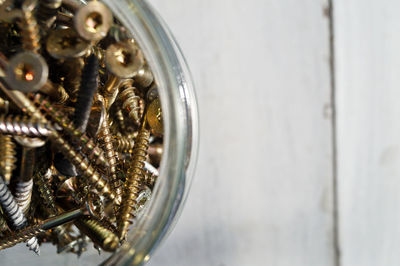 Directly above shot of screws in jar on table