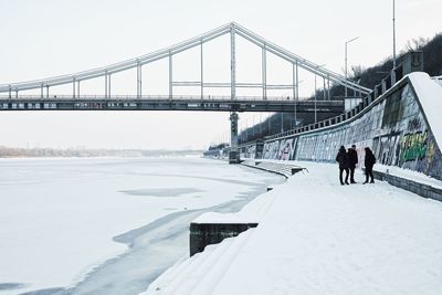 People walking on bridge in winter