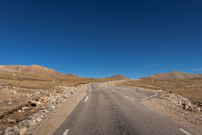 Scenic view of road against clear blue sky