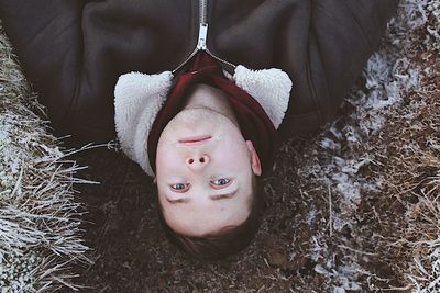 High angle view of man lying down on dirt road