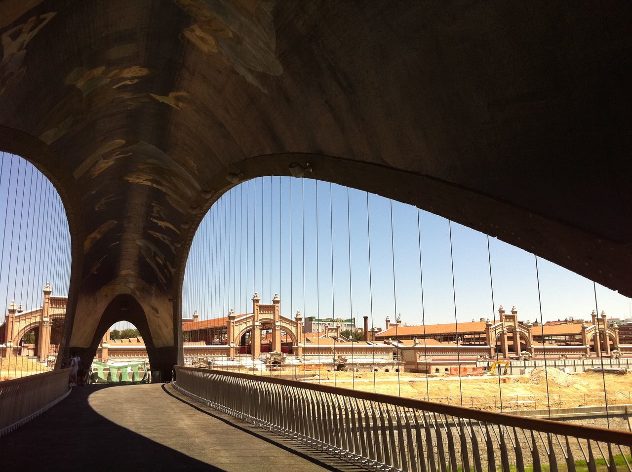 architecture, built structure, bridge - man made structure, connection, arch, building exterior, transportation, city, bridge, engineering, arch bridge, river, clear sky, sky, city life, incidental people, cityscape, railing, travel destinations, day