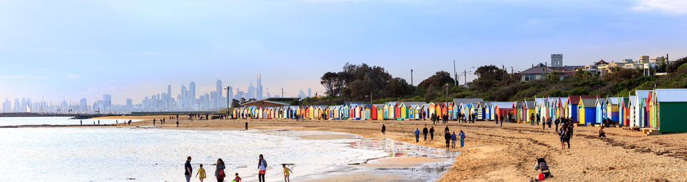 Group of people on beach against sky