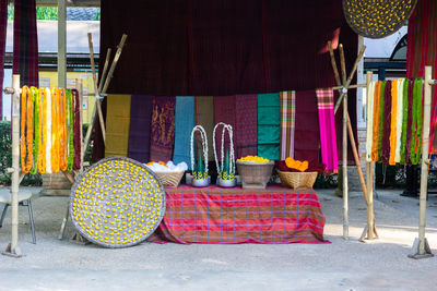 Containers against textiles for sale at market stall