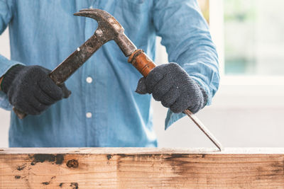 Close-up of hand holding wood