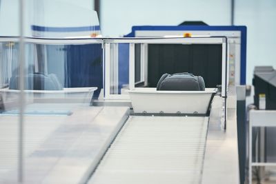 Luggage on conveyor belt at airport terminal