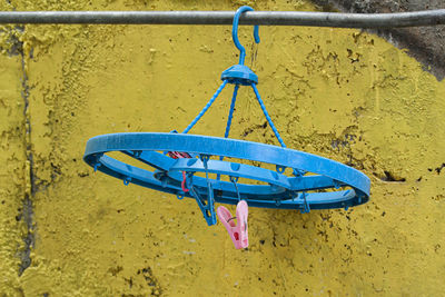 Close-up of empty playground against yellow wall