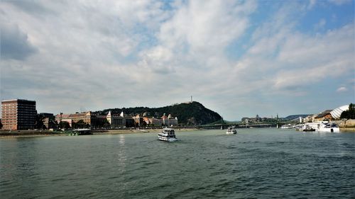 Scenic view of sea against sky in city