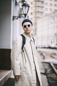 Portrait of teenage boy standing in city