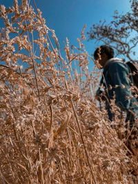 Man standing on field against sky