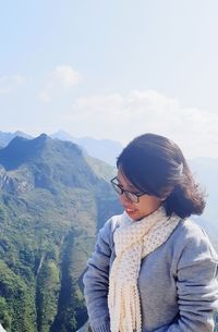 Man looking at mountains against sky