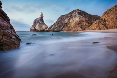 Scenic view of sea and mountains against sky