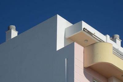 Low angle view of building against clear blue sky