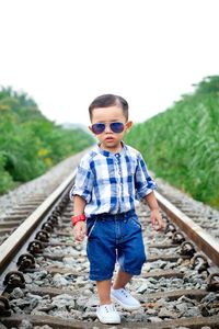 Portrait of boy in railroad tracks
