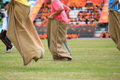 Low section of people playing on grass