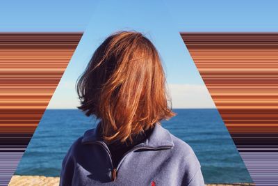 Rear view of woman standing against building