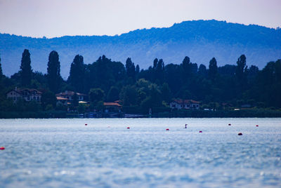 Scenic view of sea and mountains against sky