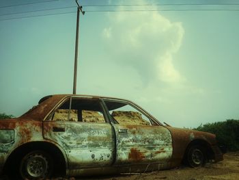 Car on road against cloudy sky